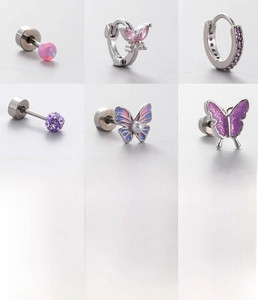 Macro detail of titanium steel screw-back earrings with purple zircon butterfly designs
