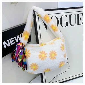 Detail of plush shoulder bag featuring white daisy patterns and decorative silk scarf wrap