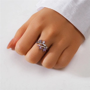 Detail of floral S925 silver ring with purple and pink zircons on hand