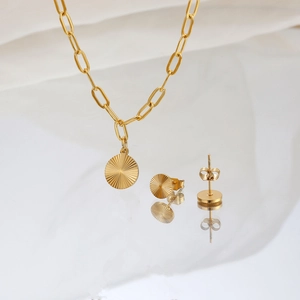 Golden sunburst pattern jewelry set with paperclip chain necklace and round studs
