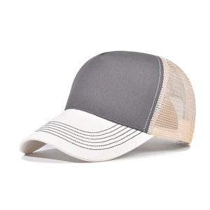 Detail view of cotton baseball cap with dark grey front and white brim with mesh back