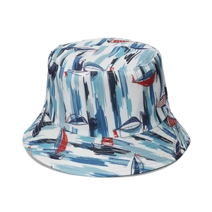 Blue and white nautical bucket hat with red sailboat pattern for sun protection