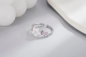 Close-up of shell cherry blossom silver ring with pink zircon and adjustable band