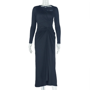Close-up of elegant black maxi dress featuring ruched details and asymmetric neckline