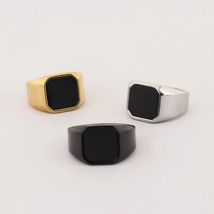 Detailed view of square black agate signet rings in gold, silver and black stainless steel