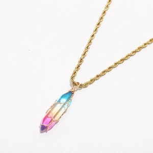 Close-up of bohemian gold rope chain and gradient crystal prism with wire wrapping