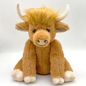 Close-up of brown Highland cow plush toy featuring realistic long fur and curved horns