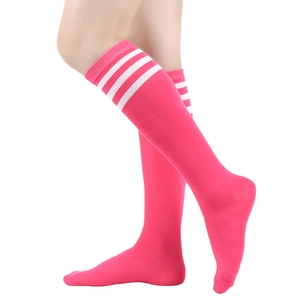 Detail view of hot pink knee-high socks with three white stripes on elastic cotton
