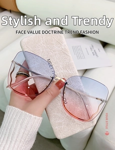 Detail of blue-pink gradient rimless lenses and wavy golden metal temples on sunglasses