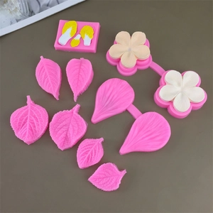 Pink and white food-grade silicone molds for fondant flower petals and leaf textures