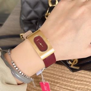 Fashionable women's watch with golden rectangular case and wine red leather strap on wrist