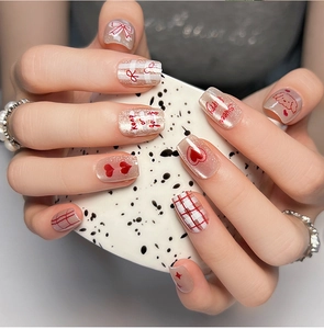Detail of sweet cat eye press-on nails with puppy, heart patterns and red plaid design