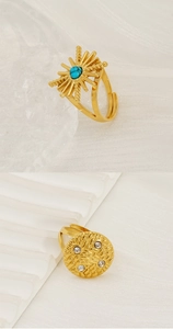Detailed view of 18k gold plated open rings with turquoise star and hammered zircon disc