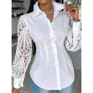 Detailed view of white long sleeve shirt with intricate lace hollow-out sleeve design