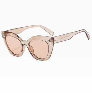 Detail view of transparent tea cat-eye frames with light orange lenses and triple rivets
