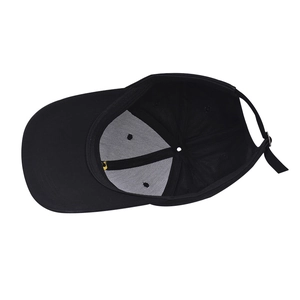 Internal view of black cotton baseball cap showing reinforced lining and adjustable strap