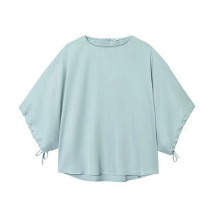 Light blue puff sleeve blouse with round neck and cuff ties on a white background