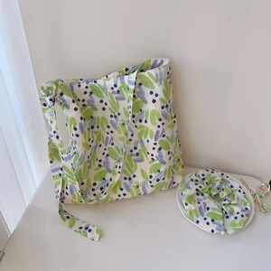 Detail of floral cotton tote bag and matching scrunchie set with leaf print