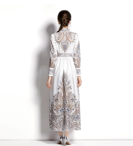 Back view of a long dress with elegant blue paisley prints and a high-waisted design