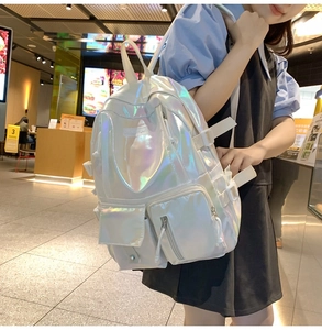 Detail view of laser PU backpack with iridescent finish and multiple utility pockets