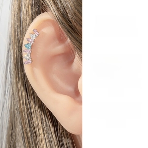 Detail of curved ear cuff featuring pink, blue, and white micro-pave zircons