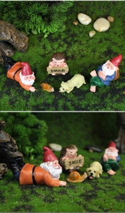 Detail of 5-piece resin garden gnome set with hedgehog holding a smile sign