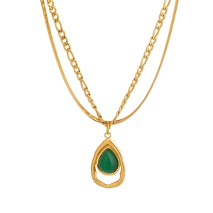 Detail of layered gold snake chain and link chain with green teardrop stone pendant