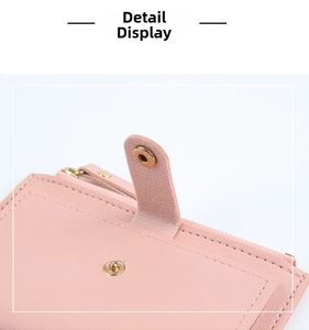 Detail of pink PU leather wallet with precision stitching and metal snap button closure