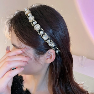 Detail of vintage pearl and crystal narrow headband worn by model showing elegant fit