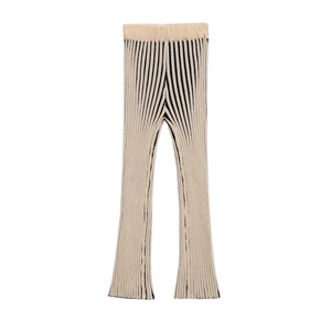 Detailed view of beige and black vertical striped knitted pants with ribbed texture