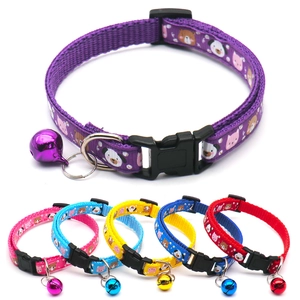 Detail showing various colors of pet collars with cute animal prints and small bells