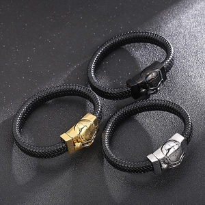 Men's braided leather bracelet with skull magnetic clasp in gold, silver, and black metal