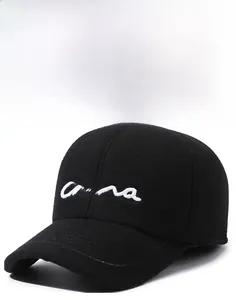 Detail of black wool baseball cap featuring white China embroidery and a stiff brim