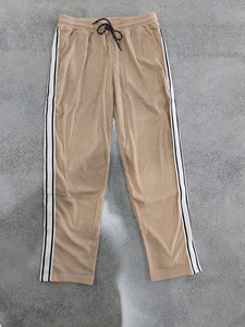 Detailed texture of khaki corduroy fabric with black drawstring and side stripes