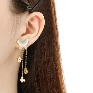 Detail of gold butterfly tassel earring with pink and blue enamel and zircon droplets