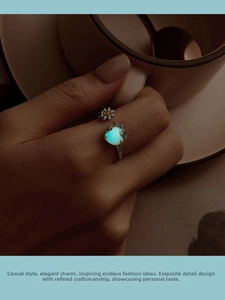Close-up of adjustable S925 silver ring with luminous bead and daisy flower detail