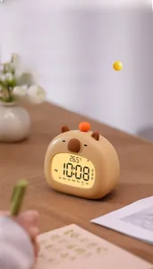 Macro shot of Capybara smart alarm clock displaying time, temperature, and weekday status