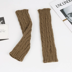 Detail of cable knit pattern on long camel brown fingerless arm warmers for winter