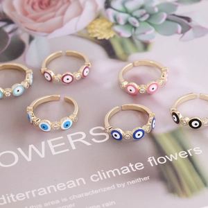 Detailed overhead shot of evil eye open rings with colorful enamel and zircon crystals