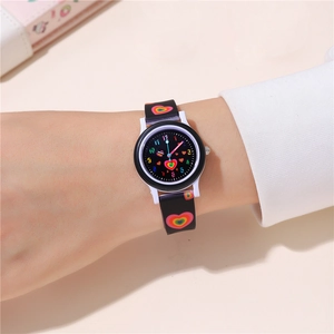 Close-up of kids quartz watch with colorful rainbow heart patterns on black silicone strap
