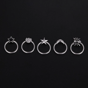 Five-piece set of silver surgical steel rings with star, spider, and moon charms