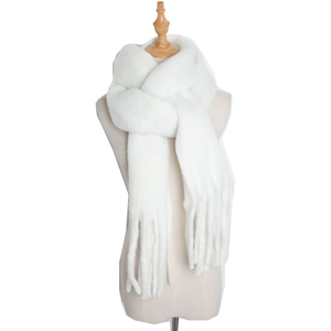 Close-up of soft white mohair scarf with tassels on a wooden base mannequin stand