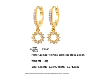 Macro detail of PVD gold plated stainless steel earrings with cubic zirconia sunburst charms