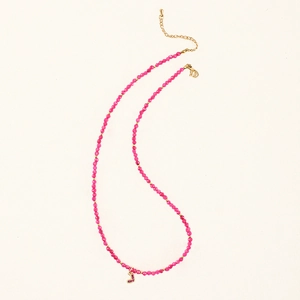 Detailed close-up of pink beaded stone necklace with a small heart-shaped pendant