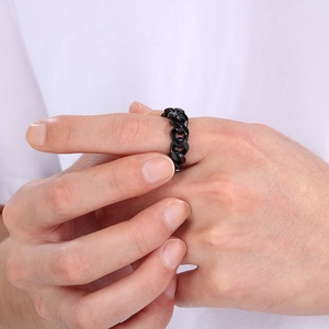 Close-up of black Cuban chain link ring made of titanium steel worn on finger