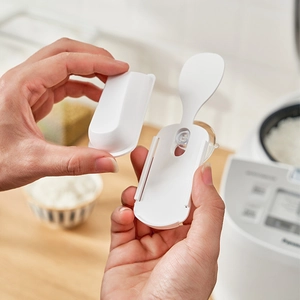 Wall-mounted suction cup rice paddle holder in white plastic for kitchen storage