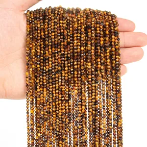 Macro detail of faceted 3mm tiger eye stone beads strand with natural chatoyant effect