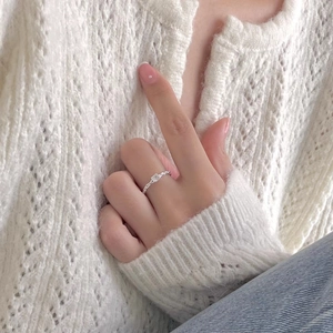 Minimalist 925 sterling silver ring with square zircon and textured band on white knit