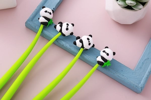 Macro shot of 4 bright green panda gel pens with cute soft rubber character toppers