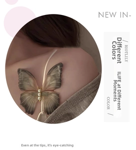 Detailed view of ethereal tulle butterfly hair clip with gradient wings and white pearls